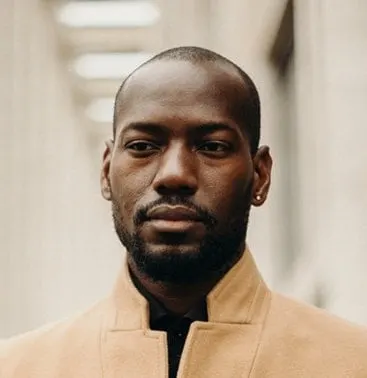 Black man with buzz cut with receding hairline