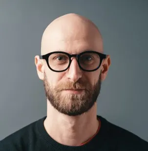 Shaved head with beard and glasses 