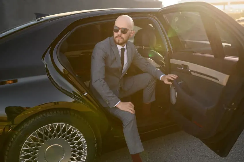 grey suit and sunglasses on bald man