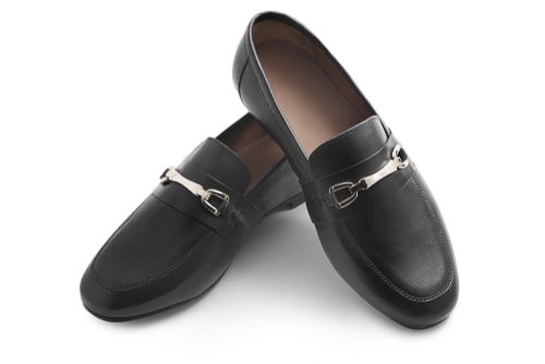 A pair of black horsebit loafers