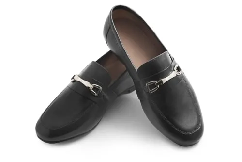 A pair of black horsebit loafers