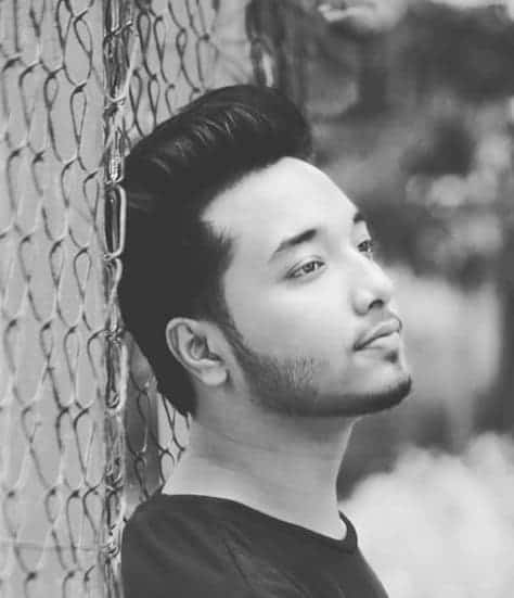 wavy pompadour with a chinstrap beard
