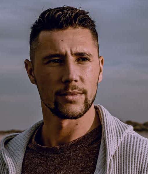 short quiff with a mid fade and goatee