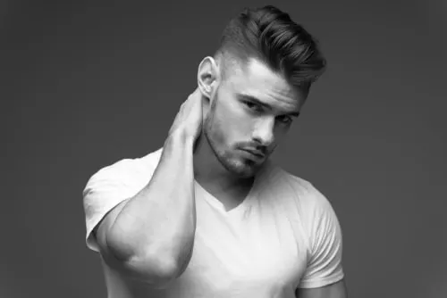 Wavy pompadour with a low fade