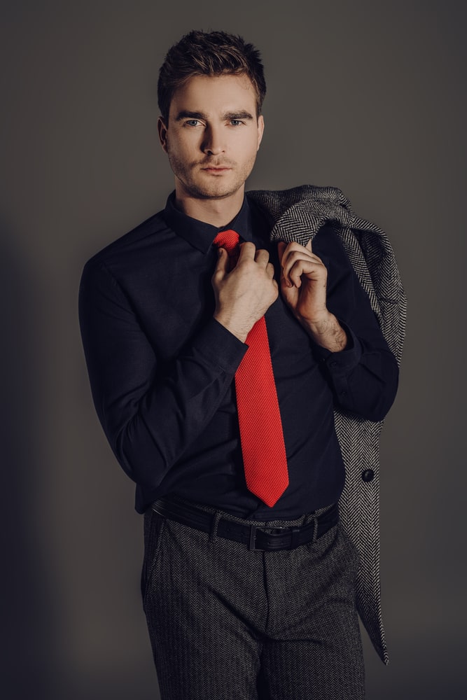 Young Man in a tight red shirt and black pants with his hands in the  pockets of trousers in the background Petrovaradin fortress and the Danube  River Stock Photo  Alamy