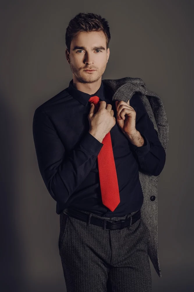 black shirt and red tie 