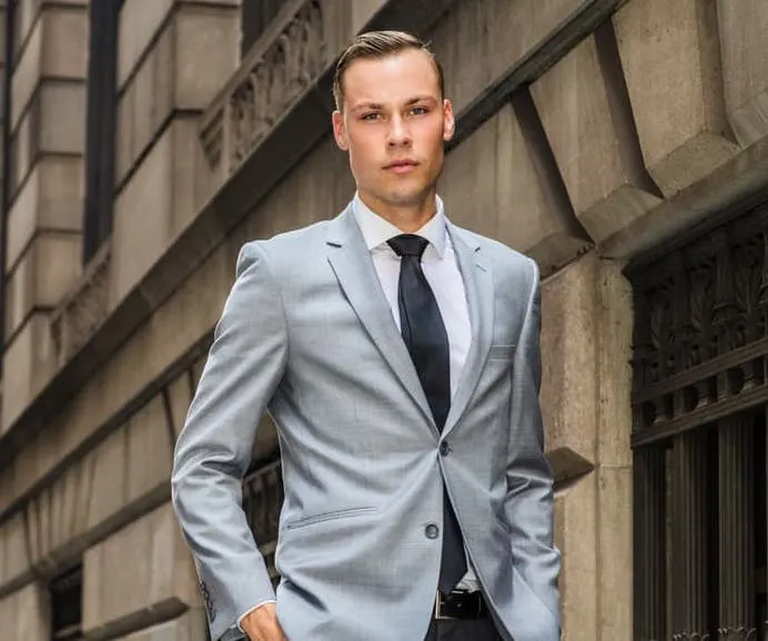 man in grey blazer and tie 