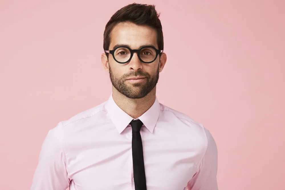 man in pink shirt and black tie