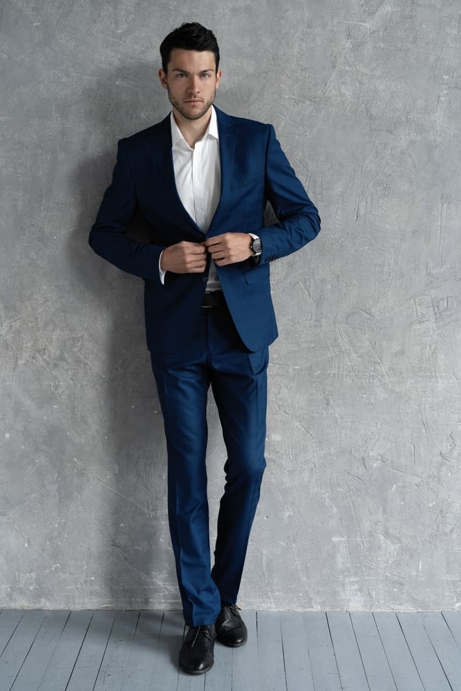 man in navy blue suit and black shoes