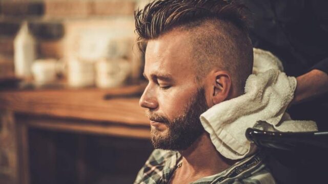 Barber finishing an undercut with clippers in a barbershop