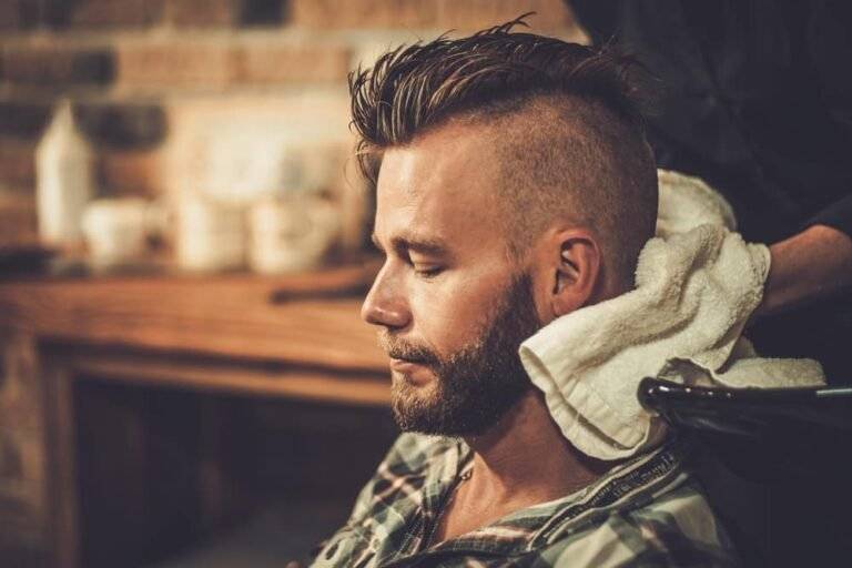 Barber finishing an undercut with clippers in a barbershop