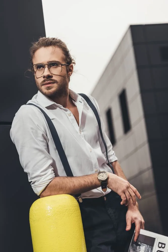 white shirt black jeans and suspenders