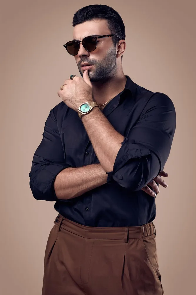 Man in black crew neck tshirt and brown pants wearing black sunglasses  standing on gray photo  Free Malang Image on Unsplash