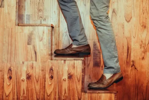 brown suede penny loafers up stairs 