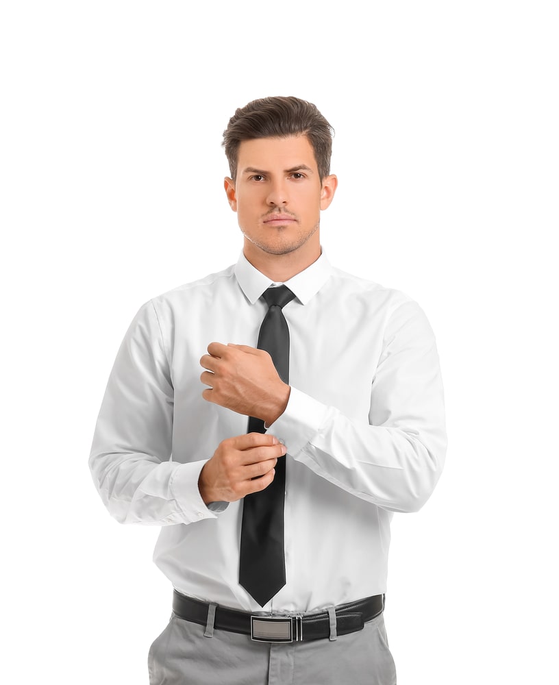 Wearing a white shirt, a black tie, gray pants, leather shoes, a young  handsome black guy is standing against a wall outside a gate, deeply  thinking Stock Photo - Alamy