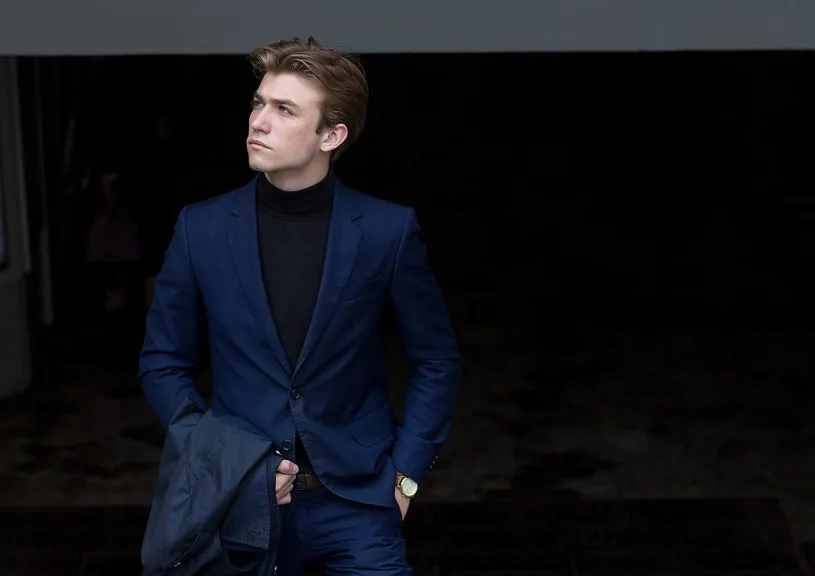 navy suit and black turtleneck shirt