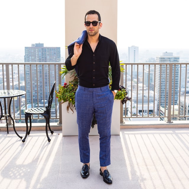 unbuttoned black shirt and blue suit