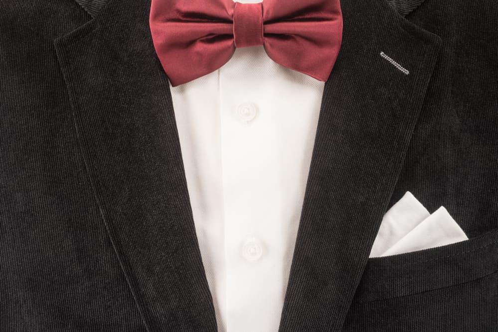 black suit and red bow tie 