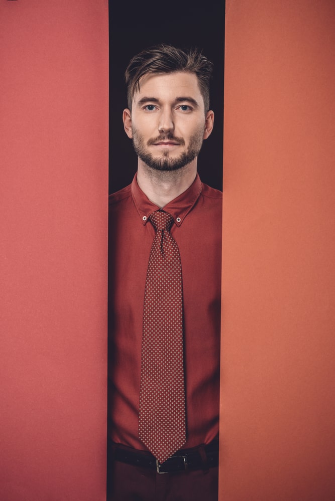 man with red shirt and red tie 