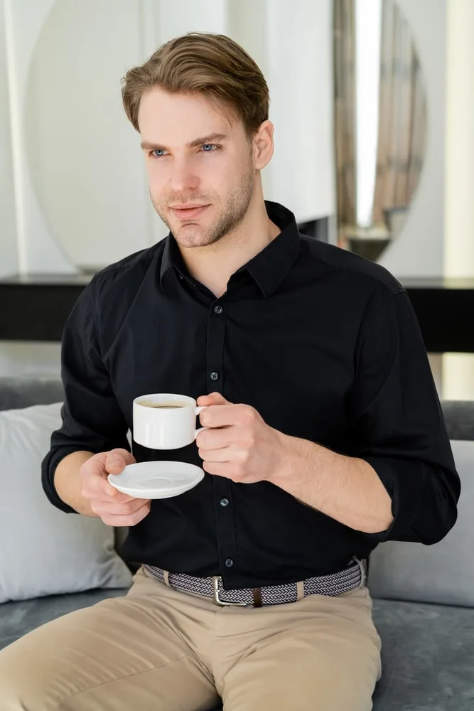 Woman in Black Shirt Brown Pants Sitting on Window Sill  Free Stock Photo