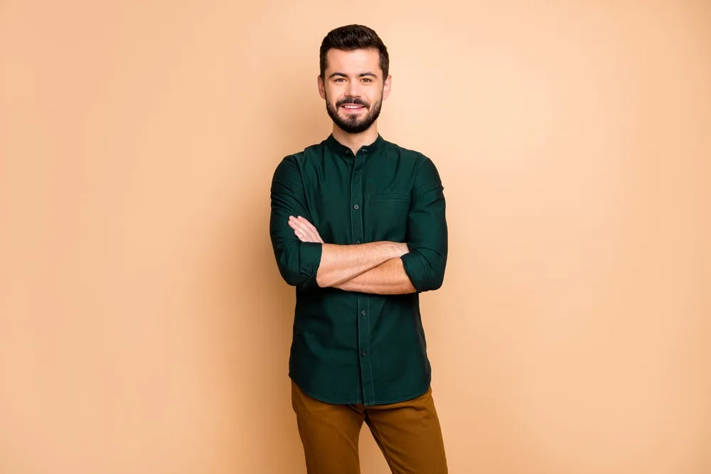 dark green shirt with brown pants