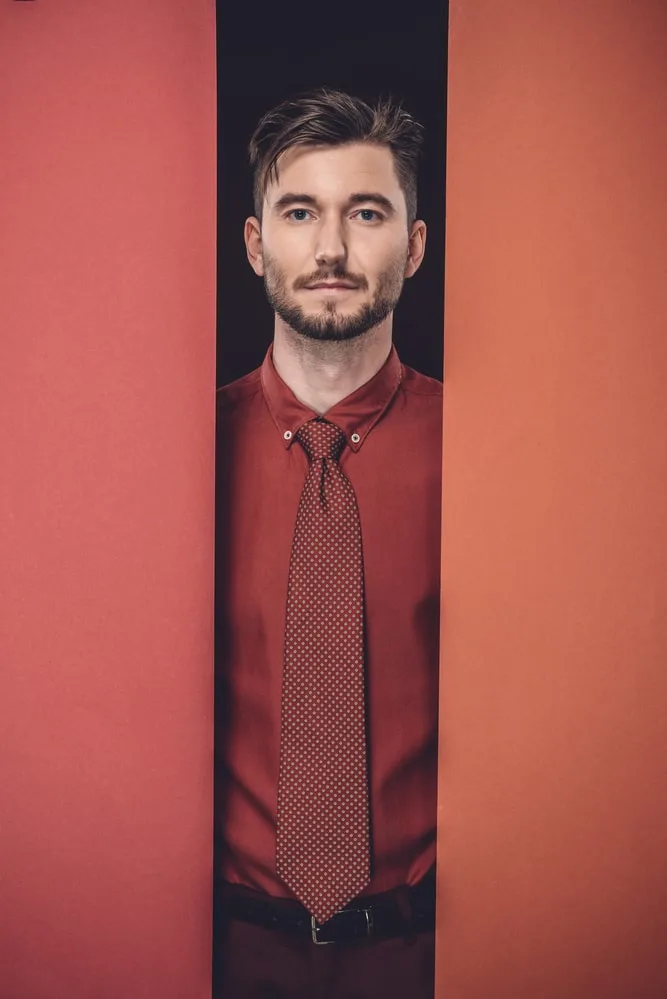 man with red shirt and red tie