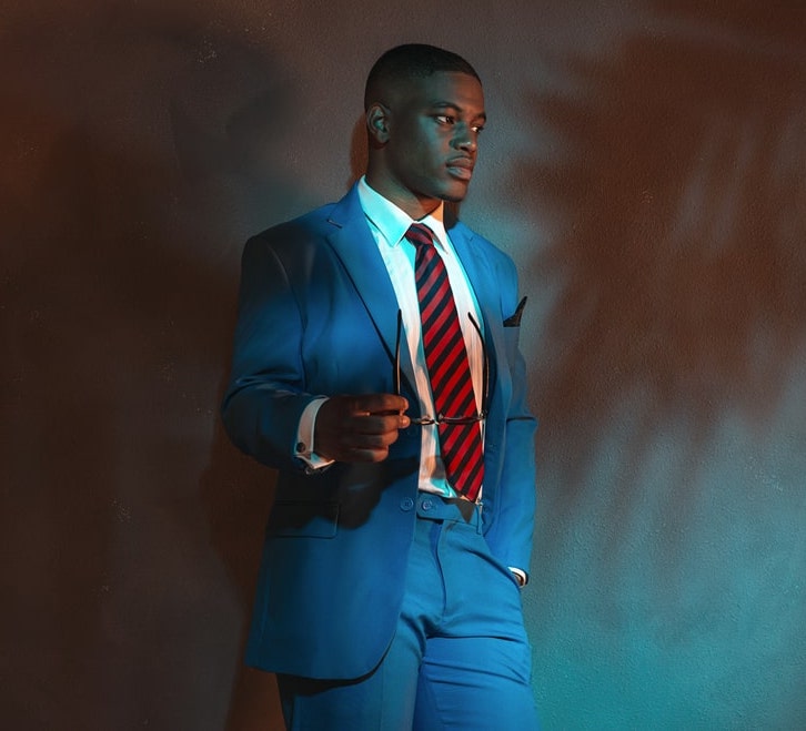 blue suit with patterned red tie