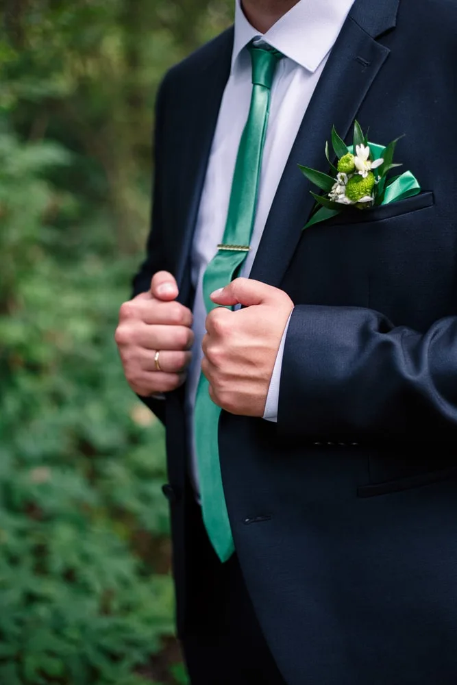 dark blue suit and light green tie 