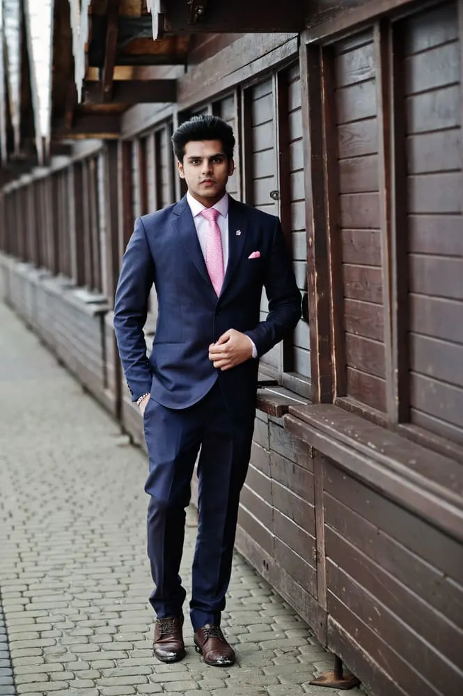 dark blue suit and pink tie 