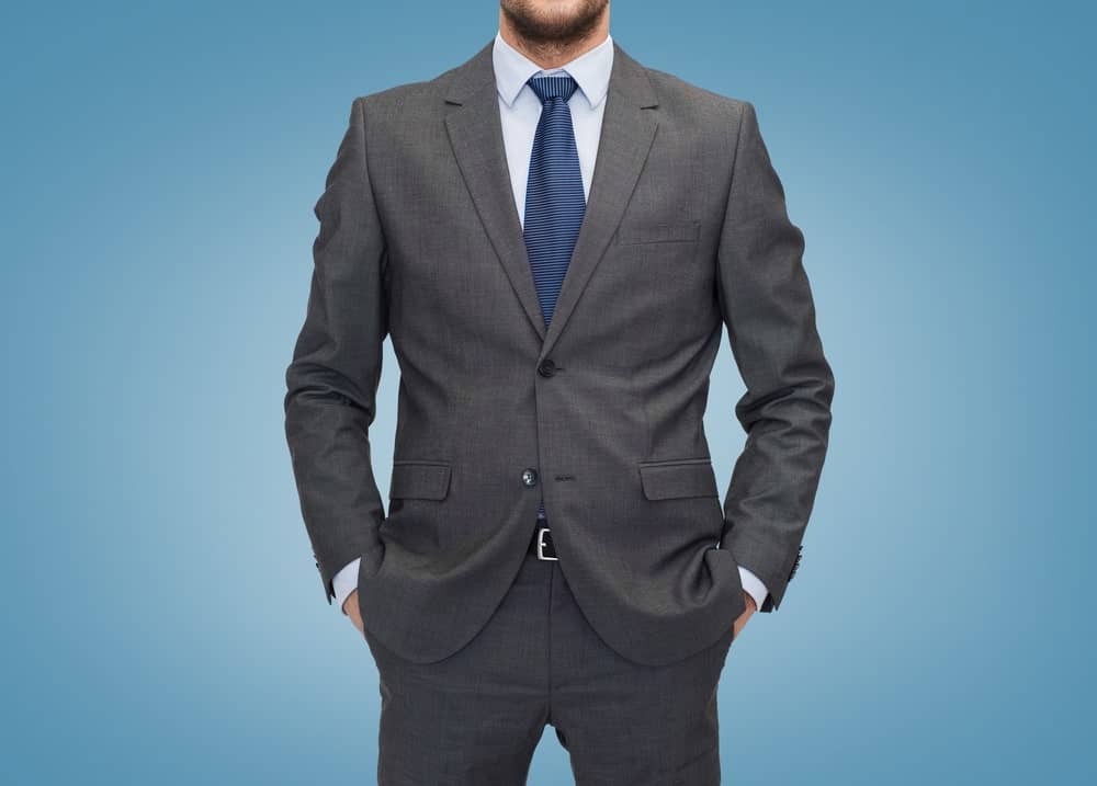 grey suit blue shirt and navy tie