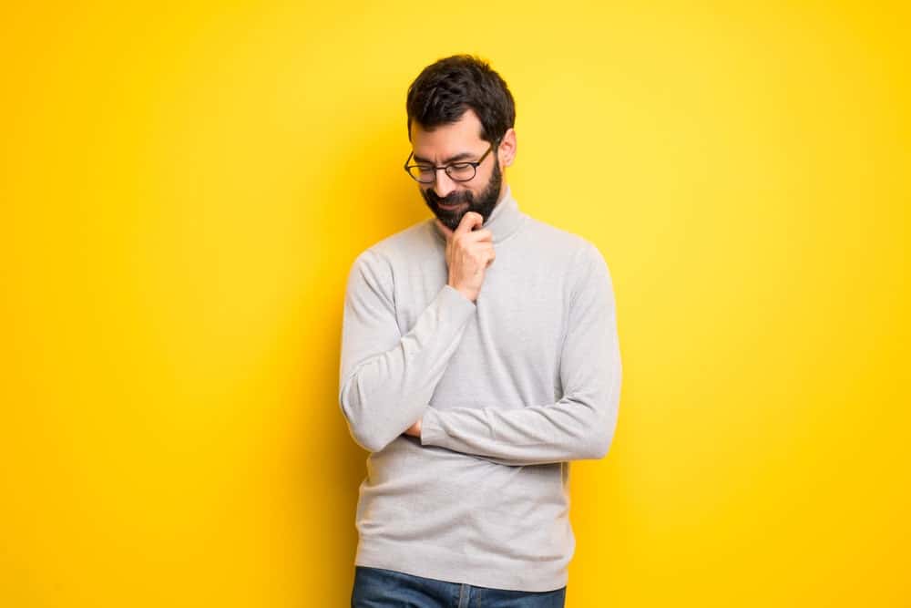 man in a mock neck sweater 