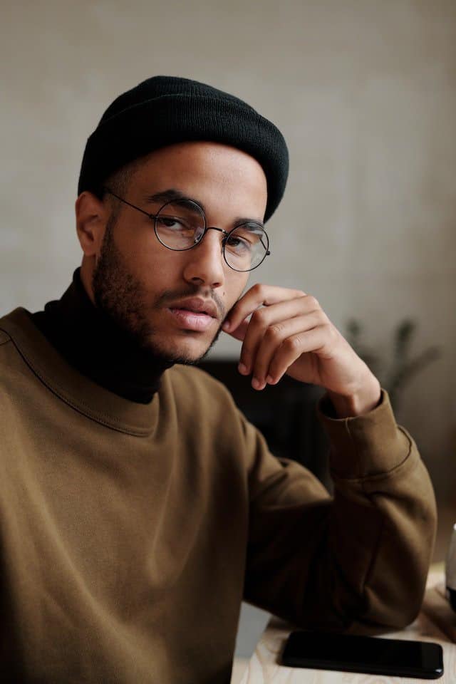 black turtleneck under brown sweater