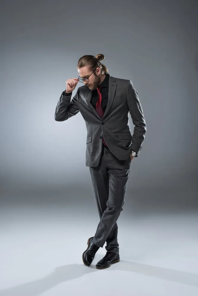 grey suit black shirt and red tie 