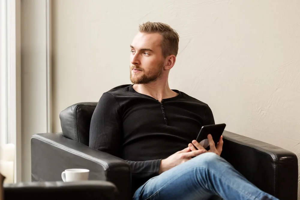 black henley shirt with light blue jeans