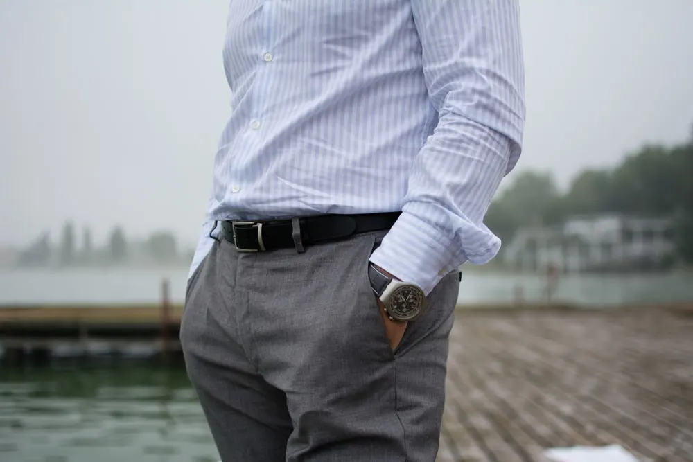 Man Looking for You Wearing a blue shirt gray pants casual shoes a  young guy with beard yellow hair is standing by old fashion style railing  in a Stock Photo  Alamy