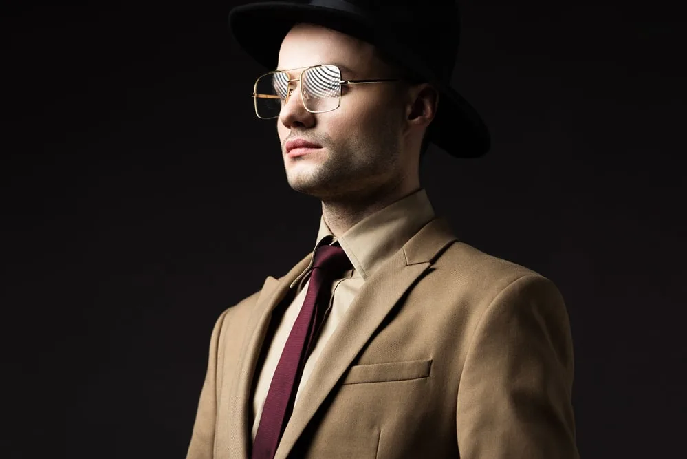 tan suit with burgundy tie