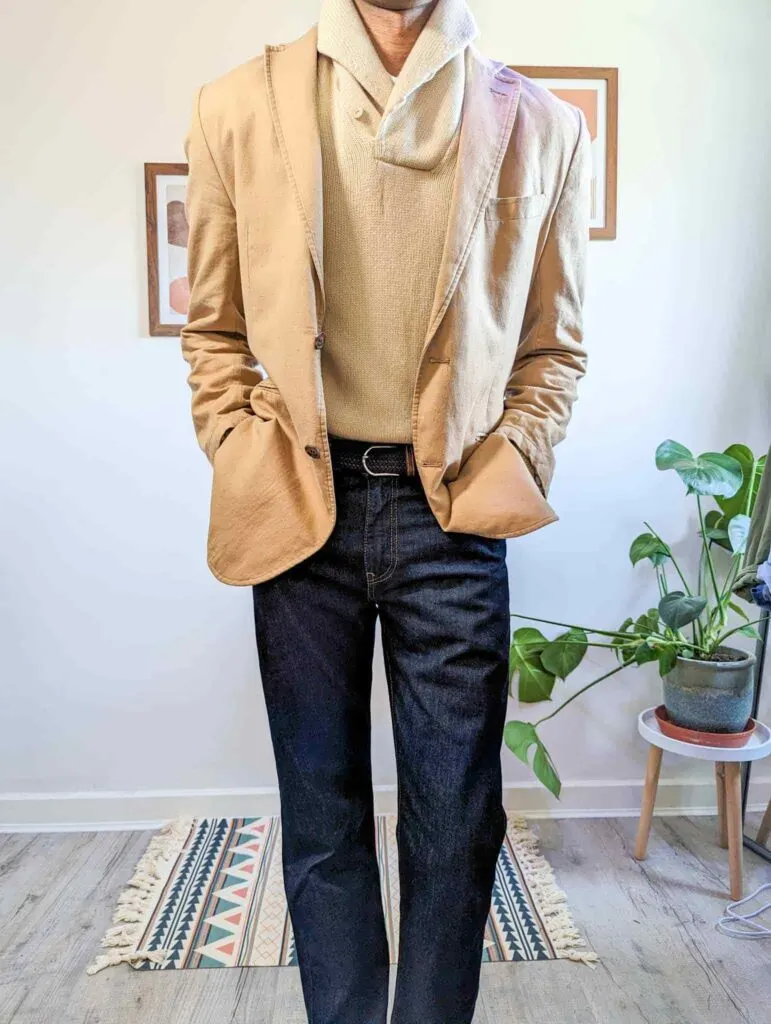 tan blazer beige shawl neck sweater dark blue jeans