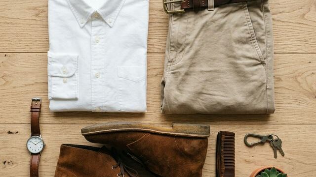 Chinos style guide flat lay with shirt, belt and desert boots